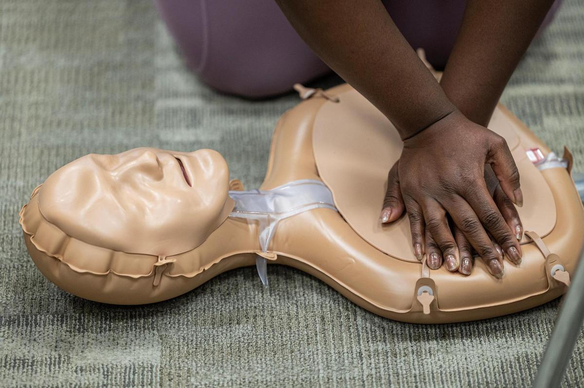 Cassandra Walker practices chest compressions during a CPR class at the Pat May Center in Bedford on Tuesday, Oct. 29, 2024.