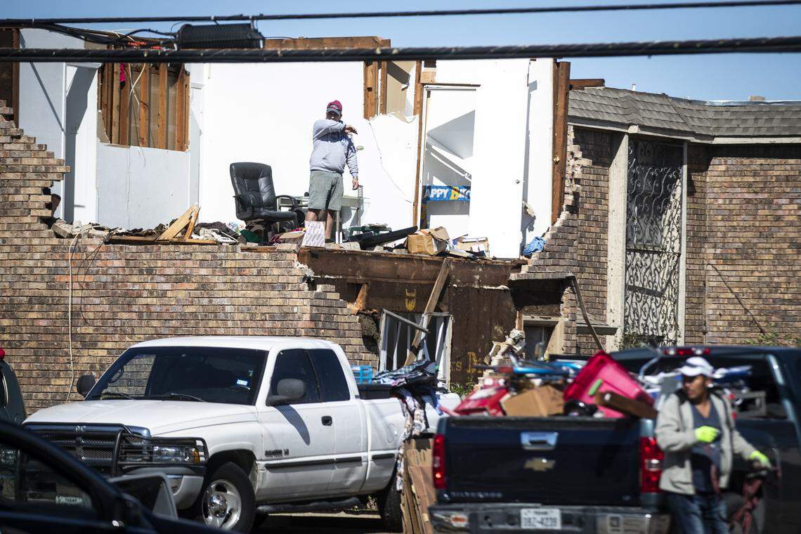 Residents survey damage after a tornado Monday, Oct. 21, 2019, in Northwest Dallas.