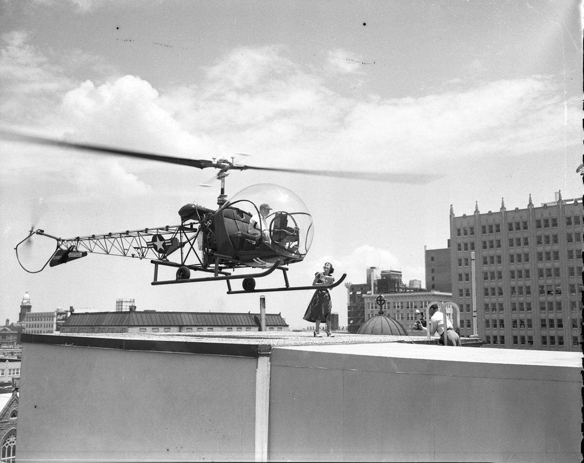 A Bell Aircraft Corp. helicopter atop the Fort Worth Star-Telegram building in downtown on May 21, 1951. Grace Halsell receives news pictures from pilot Bill Quinlan.