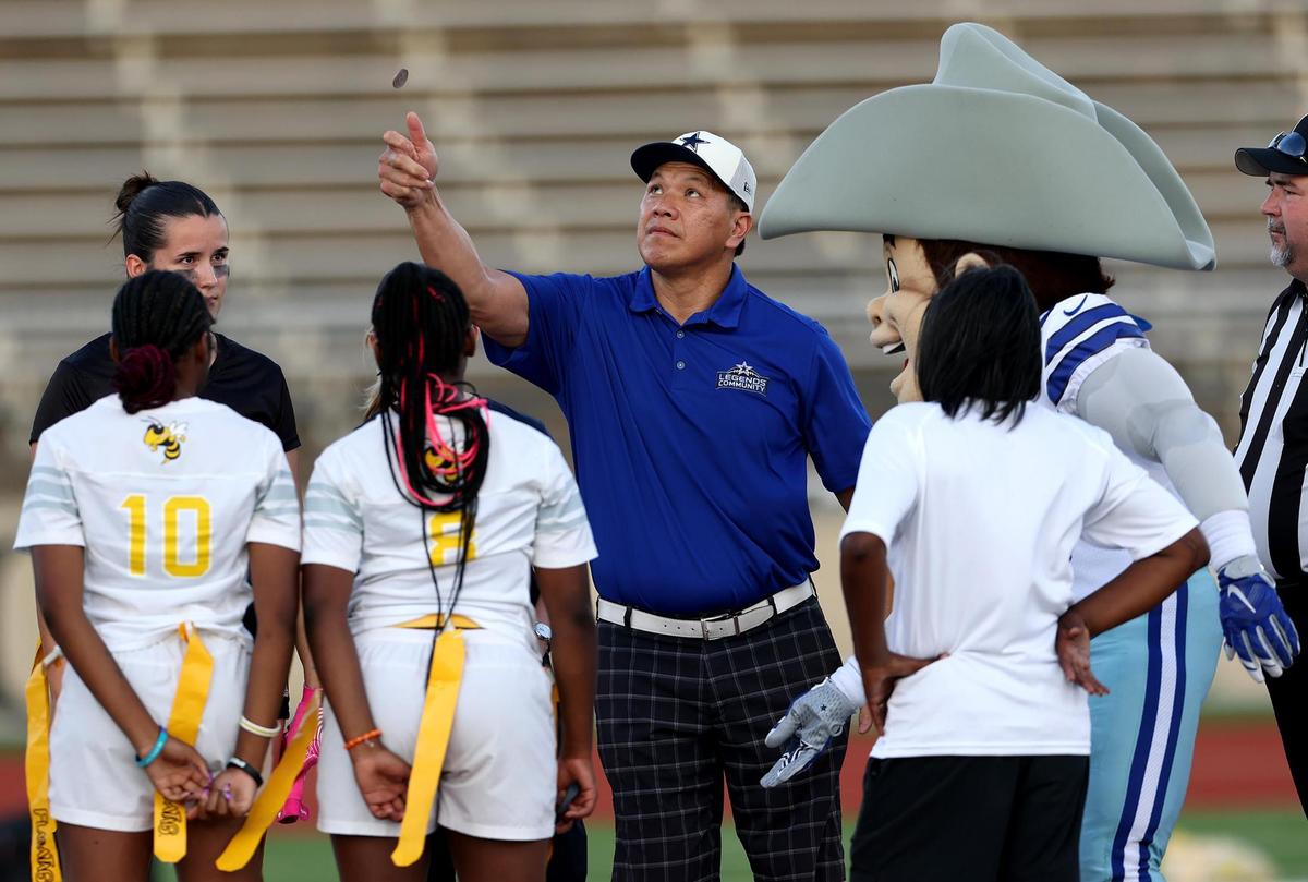 Former Dallas Cowboys inebacker Dan Nguyen flips the coin to kick off the championship girls’ flag football game between Paschal and Arlington Heights on Tuesday, May 13, 2025, at Herman Clark Stadium.