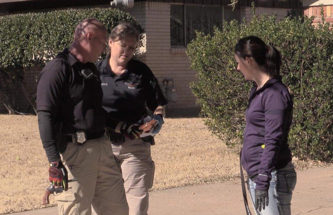 Fort Worth CIT officers Kelley French (Middle), Andy Lebensieg (Left) and Tarrant County My Health My Resources Program Manager Leah White (Right) discuss weapons found in a woman's home during a wellness check.