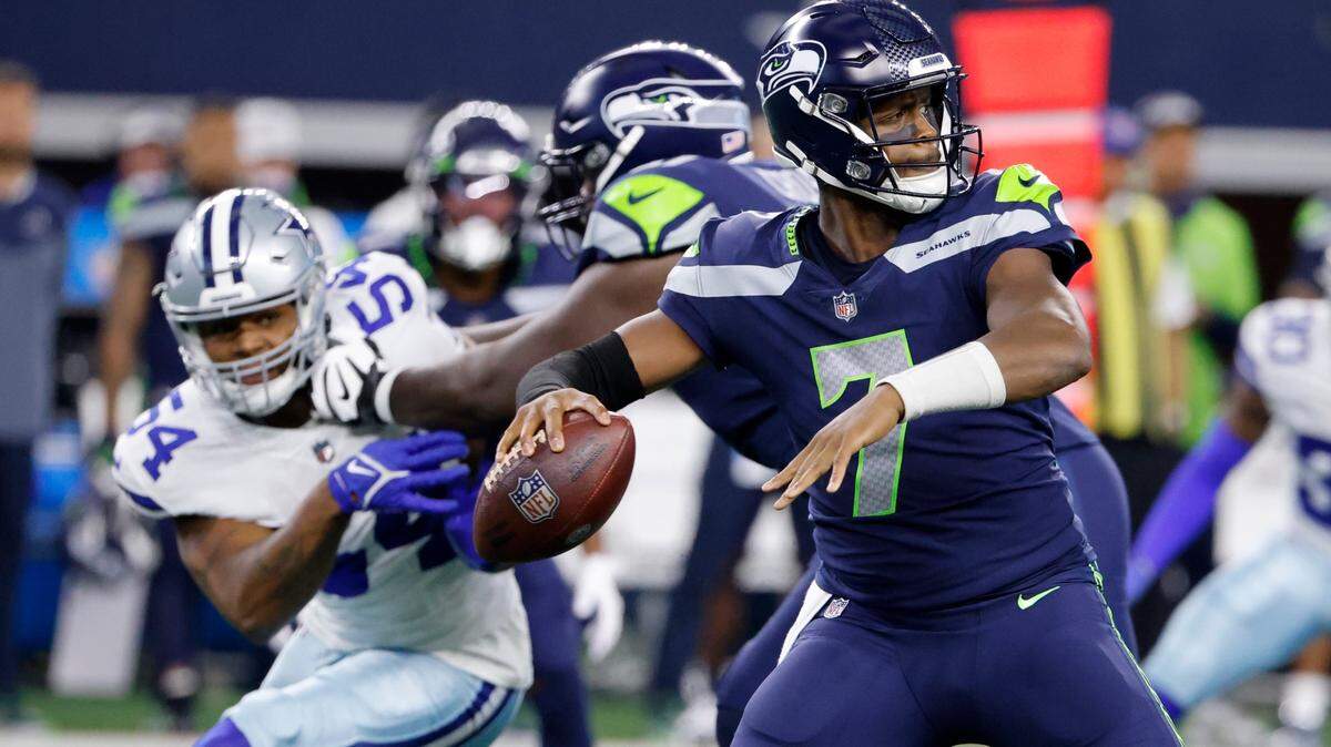 Seattle Seahawks quarterback Geno Smith (7) prepares to throw a pass under pressure from Dallas Cowboys defensive end Sam Williams (54) in the first half of a preseason NFL football game in Arlington, Texas, Friday, Aug. 26, 2022. (AP Photo/Ron Jenkins)