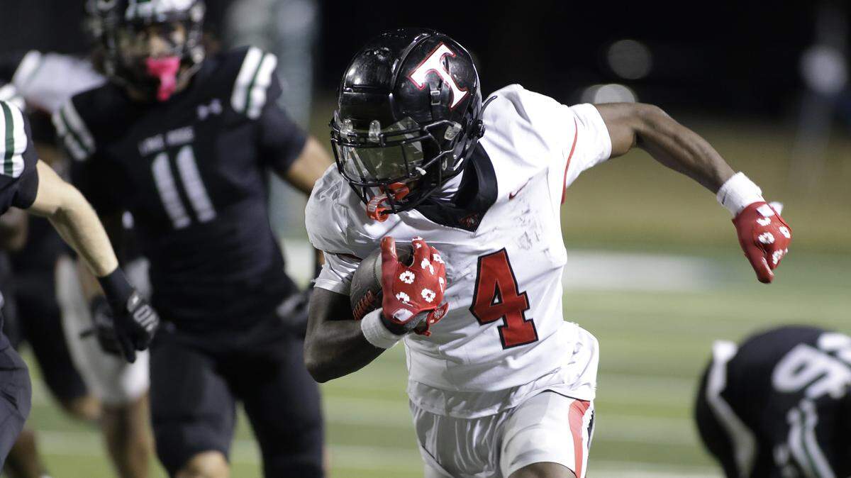 Euless Trinity running back Keondre Dixon (4) breaks free for a touchdown against Mansfield Lake Ridge during their Class 6A Division I bi-district game on Friday, November 14, 2025 at Newsom Stadium in Mansfield Texas.