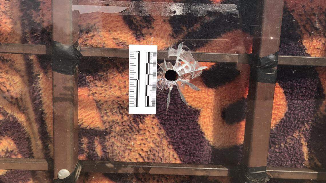 A bullet hole is visible at the Fort Worth Gold and Silver pawn shop following a robbery and shootout on July 5, 2018.