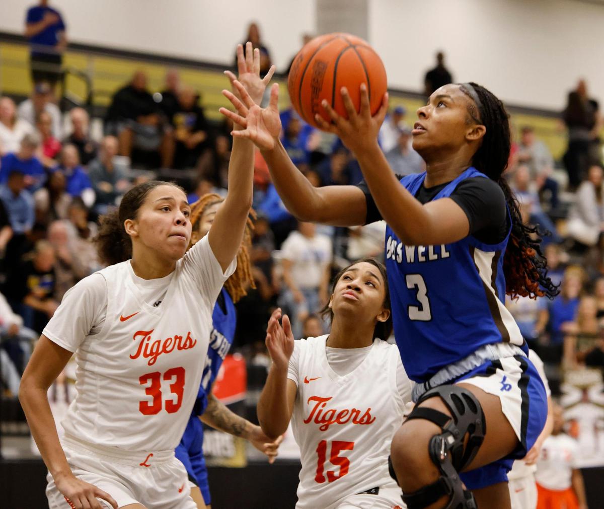 Fort Worth Boswell guard Seleste Massey (3) puts one in defended by Lancaster post Breanna Morrison (33) and guard Mckenzie White (15) during the second half of the UIL Class 6A D2 state semifinal girls basketball game at The Colony High School in The Colony, Texas, Tuesday, Feb. 25, 2025.
