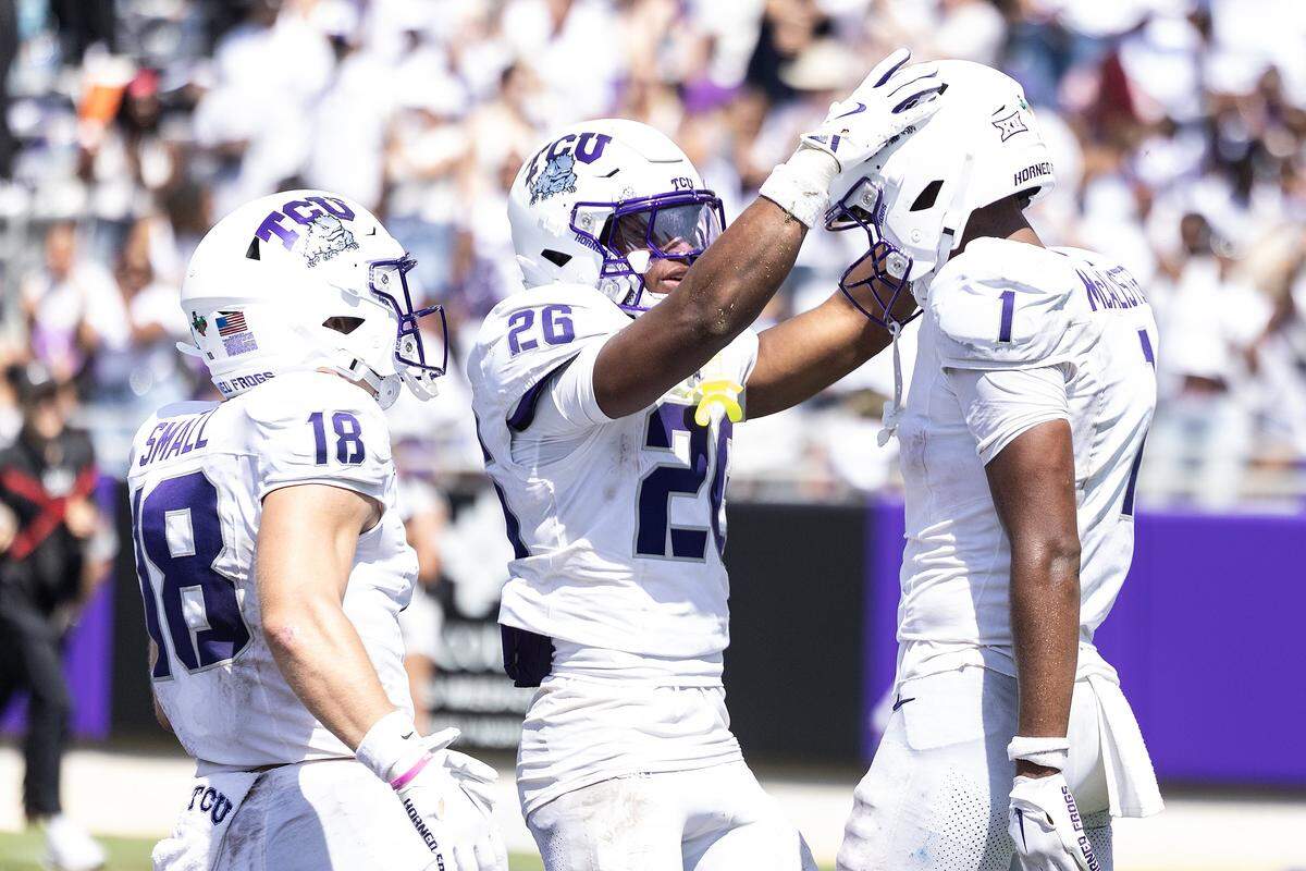 TCU wide receiver Ed Small (18) and running back Jeremy Payne (26) celebrate with wide receiver Eric McAlister (1) after he scored a touchdown in the second half of an NCAA football game between TCU and SMU at Amon G. Carter Stadium in Fort Worth on Saturday, Sept. 20, 2025. TCU won 35-24 in the final Iron Skillet Rivalry game.