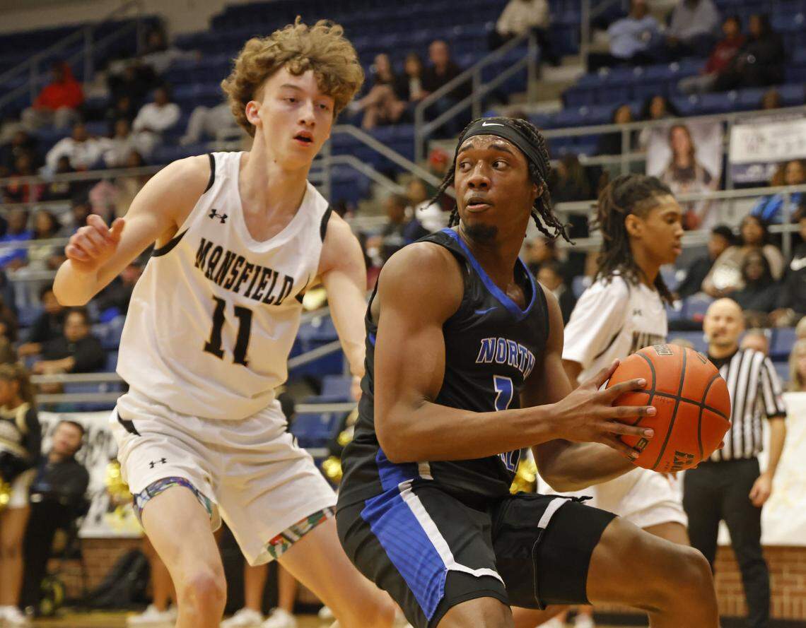 North Crowley shooting forward Alex Barther (1) looks to get the ball around Mansfield's Jack Larsen (11) during the first half of a UIL boys basketball game between North Crowley and Mansfield at Mansfield High School in Mansfield, Texas, Tuesday Jan. 20, 2026