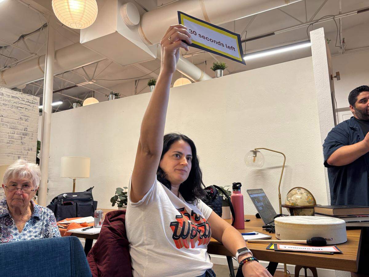 People’s Commissioners Court attendee Nydia Cardenas notified the public commenters how much time was left for them to speak in their allotted three minutes.