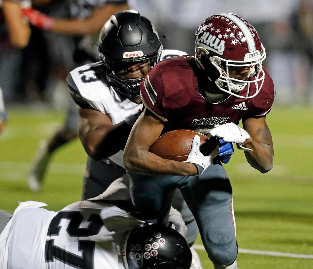 Timberview linebackers Kye Nash (13) and Deshaun Pratt (27) bring down Ennis running back Dee Johnson (2) in a class 5A Division 2 area round football playoff game at Lumpkins Stadium in Waxahachie, Texas, Friday Nov. 19, 2021. Timberview moves on in the playoffs defeating Ennis 42-21. (Special to the Star-Telegram Bob Booth)