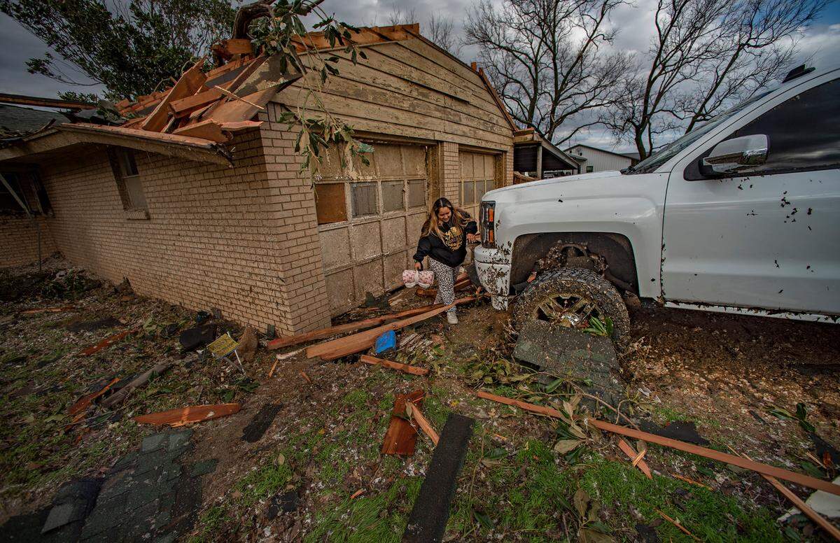 Marisol Gonzalez checks on the damage on her truck.