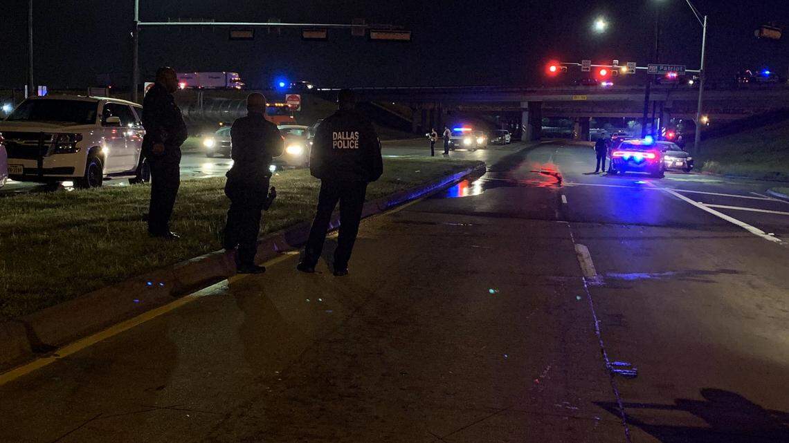 Dallas police officers respond to an incident early Tuesday morning in which officers shot and injured a man who had reportedly begun firing at them.