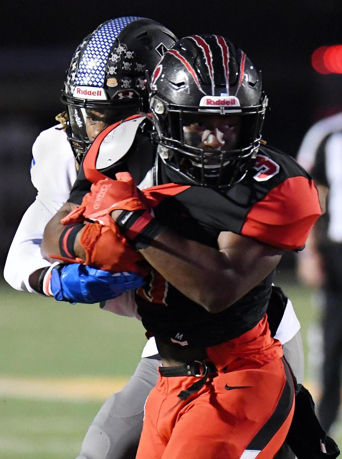 Colleyville Heritage’s Isaac Shabay, front is tackled by Mansfield Summit’s Sean Smith after a catch for a first down during the fourth quarter of their Division 1-5A Regional Round Play-off football game Saturday, December 26, 2020 at Bearcat Stadium in Aledo, Texas. Summit went on to win 34-31. Special/Bob Haynes