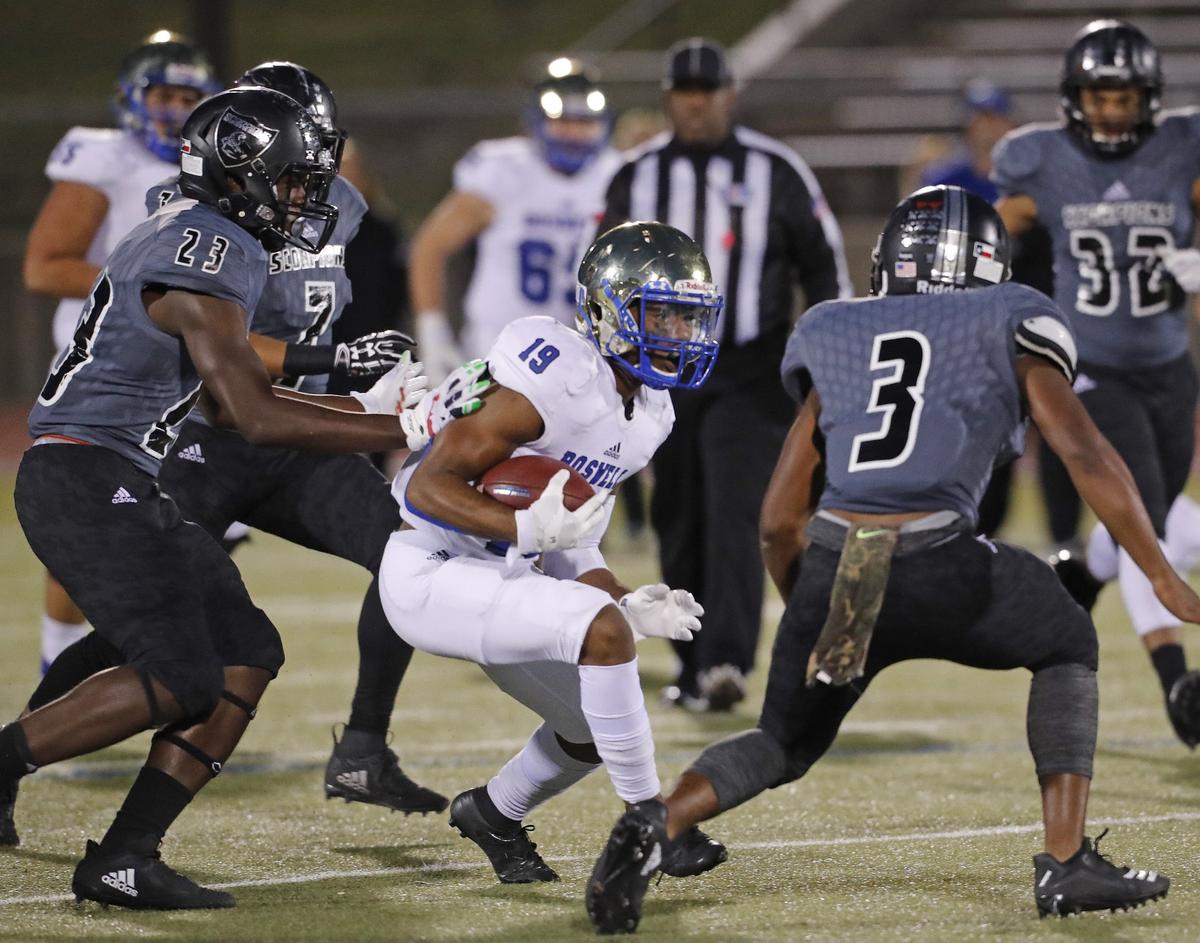 Boswell wide receiver Brandon Chatman (19) attempts to evade the defense of South Hills linebackers Ca’lub Holloway (23) and Joe Weathered (3) during the first half of a high school football game at Clark Stadium Thursday, Oct. 25, 2018. South Hills led 13-9 at the half. (Special to the Star-Telegram Bob Booth)