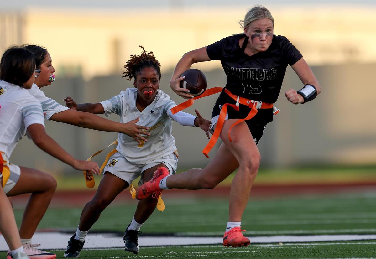 Paschal quarterback Annie Parsons slips past the Arlington Heights defense during the FWISD girls’ flag football championship on Tuesday, May 13, 2025, at Herman Clark Stadium.