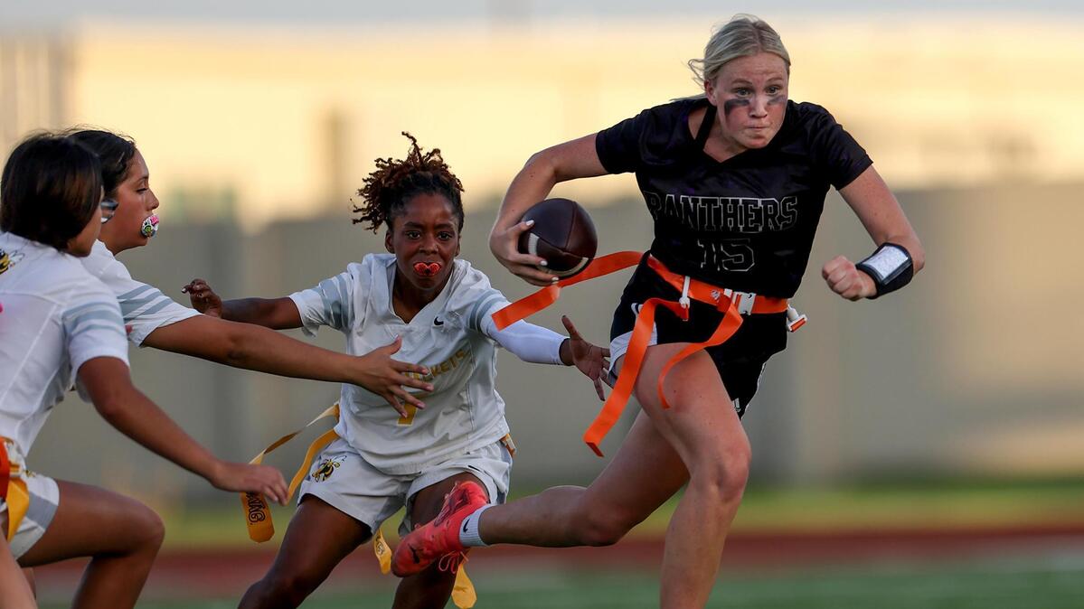 Paschal quarterback Annie Parsons slips past the Arlington Heights defense during the Fort Worth ISD girls flag football championship May 13 at Herman Clark Stadium.