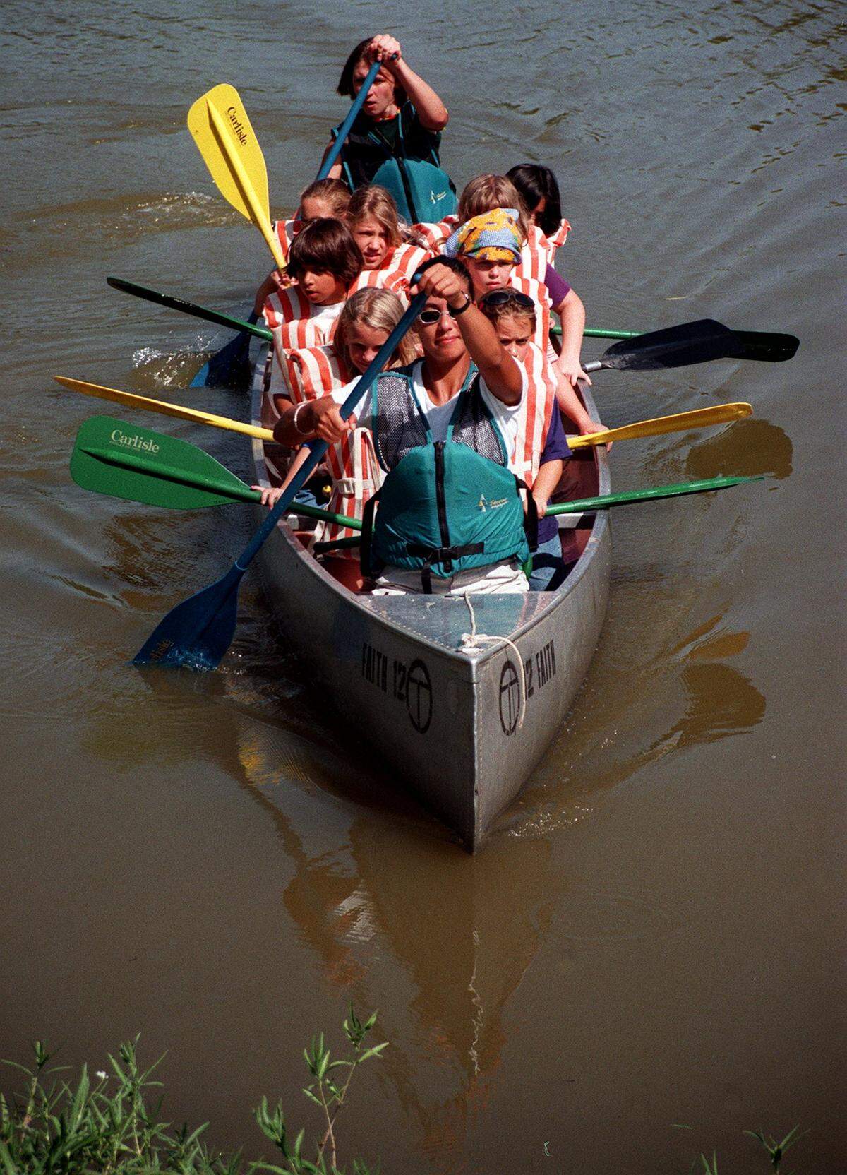 July 14, 1999: Camp Timberlake counselor Evelyn Voss, from Holland, in the front of the boat, brings in a load of Girl Scouts during a canoing session at the camp.