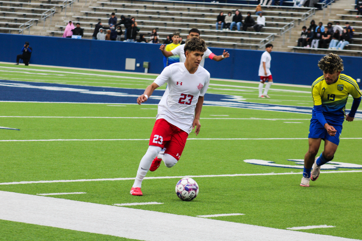 Castleberry’s Eddie Zapata (23) moves up the pitch chased by Nevada Community’s Julio Gonzalez (19) in a Class 4A Division 1 state semifinal on Saturday, April 5, 2025 at McKinney ISD Stadium in McKinney, Texas. Castleberry defeated Community 2-0.
