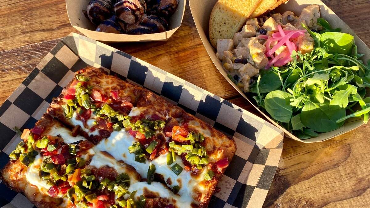 A deep-dish jalapeno-bacon-cream-cheese pizza, poached chicken salad on greens and mocha nuggets at 817 Pizza.