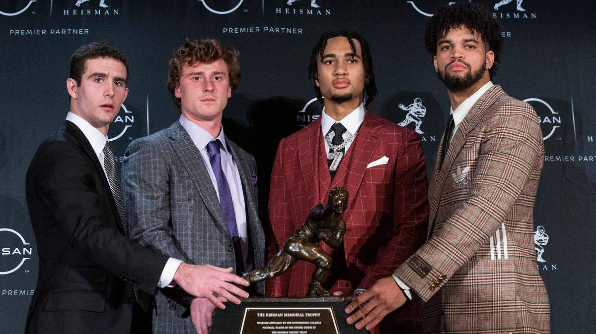 The Heisman trophy finalists, Georgia quarterback Stetson Bennett, TCU quarterback Max Duggan, Ohio State quarterback C.J. Stroud and Southern California quarterback Caleb Williams, from left, stand for a photo with the trophy before attending the award ceremony on Saturday in New York.