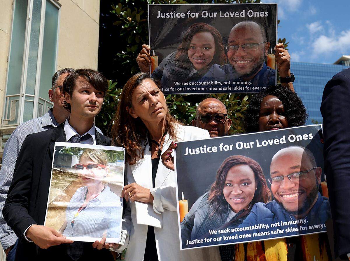 Families of victims of the 2019 Boeing 737 Max jetliner hold photographs of their loved ones outside of the federal court in Fort Worth on Wednesday, Sept. 3, 2025. Relatives of the crash victims were allowed to speak in a hearing on the U.S. government's motion to dismiss a felony conspiracy charge against Boeing. 