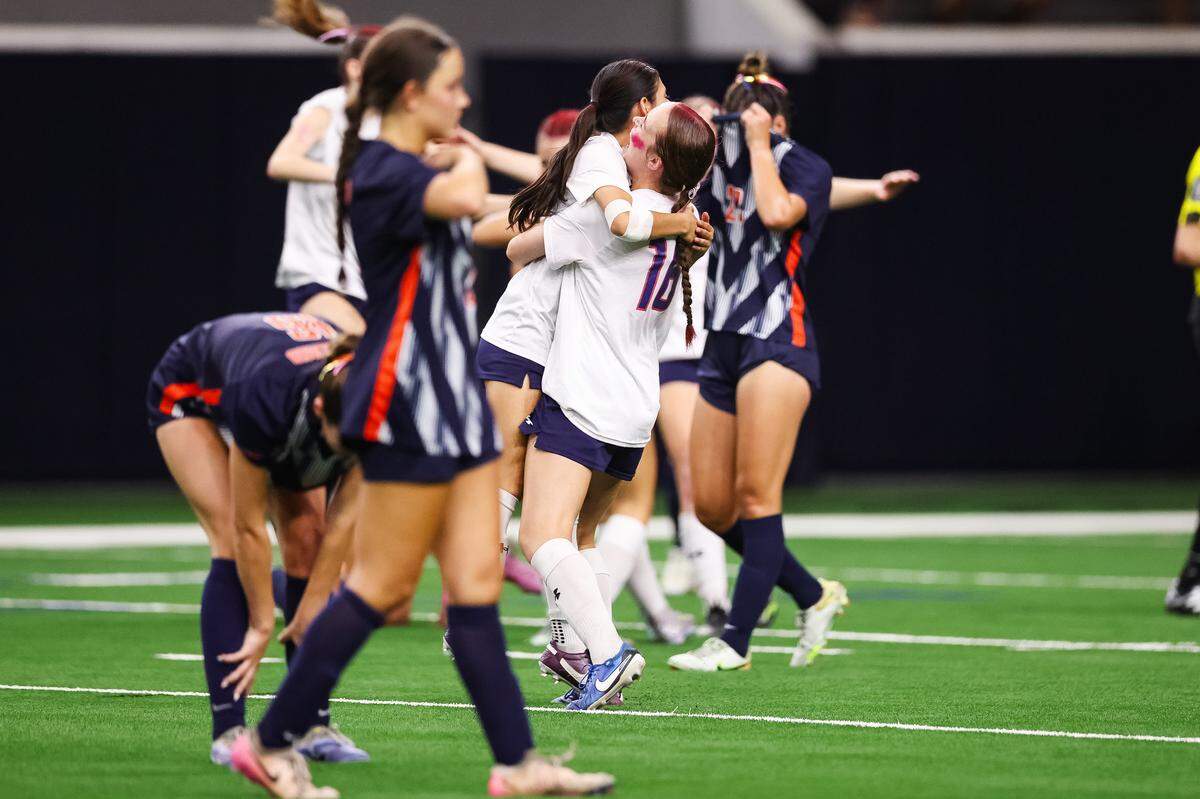 Grapevine midfielder Ella Wilson (16) hugs her teammate as Frisco Wakeland players breakdown in emotion after a Class 5A Division II UIL girls soccer state semifinal at the Ford Center on April 3, 2026 in Frisco, Texas.