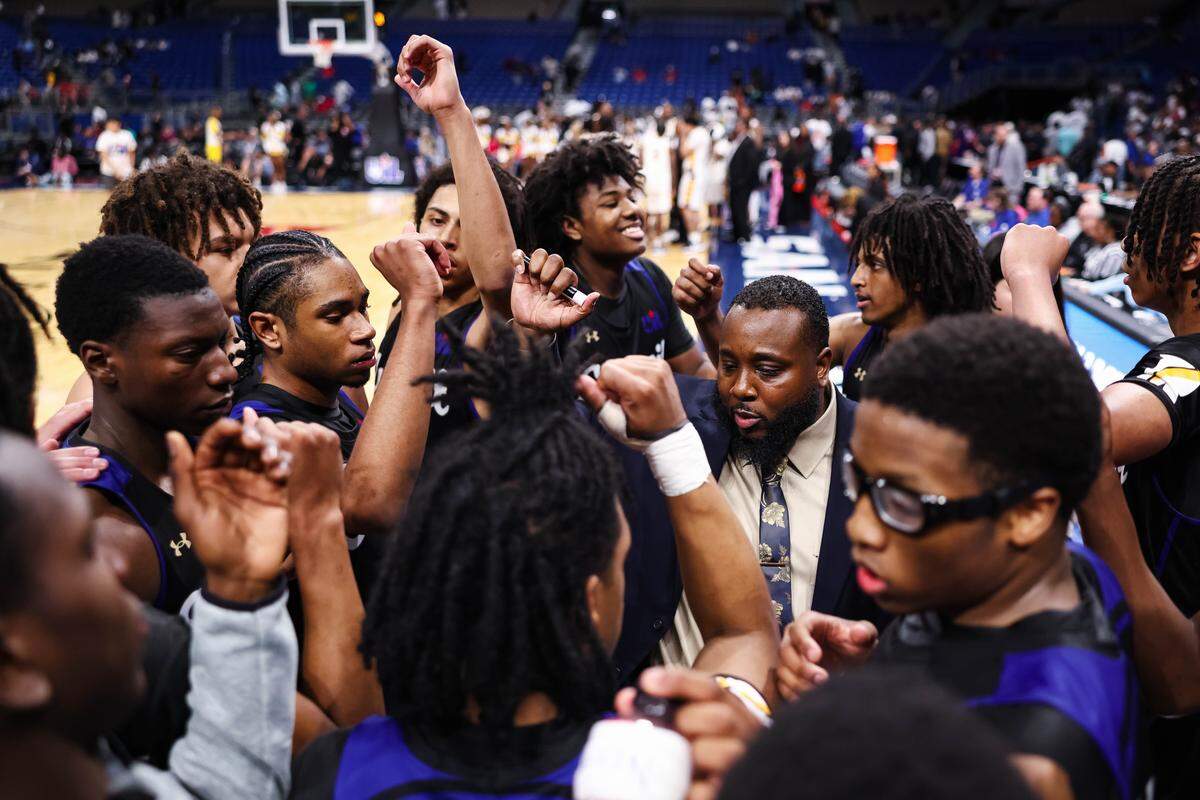Mansfield Summit head coach Emund Prichett and his team gather in a huddle near the end of the Class 5A Division II state championship game Saturday at the Alamodome in San Antonio.
