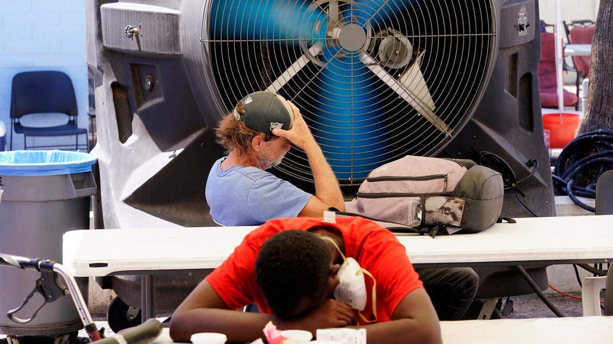 People try to keep cool at the Justa Center in Phoenix as temperatures hit 110-degrees Tuesday, July 19, 2022. (AP Photo/Ross D. Franklin)