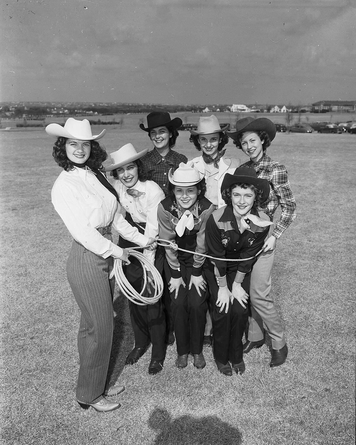 March 17, 1951: June Prichard, the 19-year-old Ranch Week queen at TCU, holds the lasso around Southwest Conference representatives. They are, left to right, front row, Regina Prikryl, Penelope, Texas; Charlotte Williams, Munday, from TSCW representing A&M and Nina Shannon, Houston, Rice; back row, left to right, Marietta Beard, Taft, Baylor; Janet Toney, Pine Bluff, Arkansas, and Jeane Doonan, Chicago, SMU.