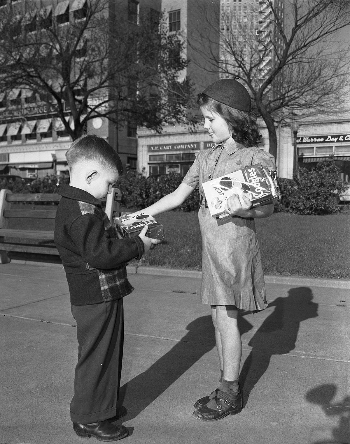 March 28, 1951: Cookies are right up a 4-year-old’s alley, so John Baker, son of Mr. and Mrs. John Earl Baker of 2016 Binkley, finds Brownie Scout Joy Kite, just the girl he has been looking for. Joy, who is the daughter of Mr. and Mrs. Haun Kite of 4924 Hovenkamp, will join other Scouts in the sale of Girl Scout cookies.