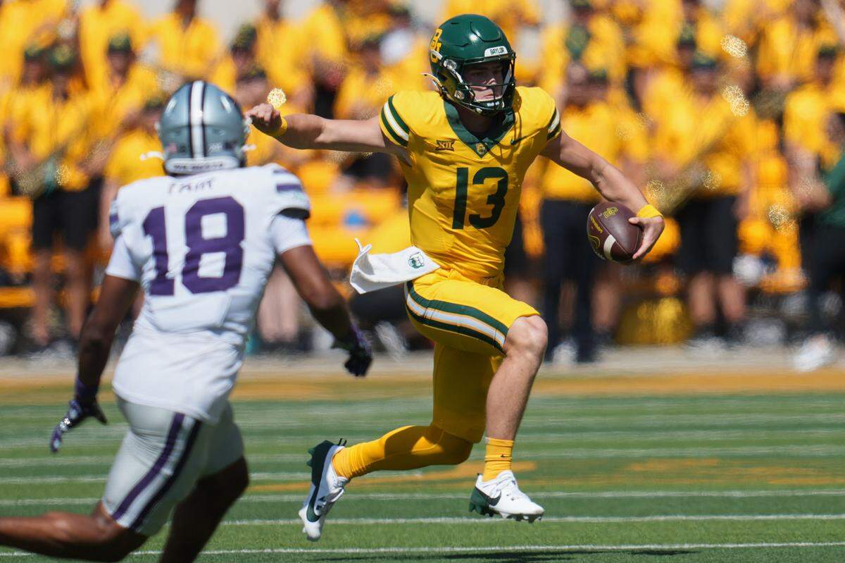 Oct 4, 2025; Waco, Texas, USA; Baylor Bears quarterback Sawyer Robertson (13) runs with the ball against Kansas State Wildcats safety Wesley Fair (18) during the second half at McLane Stadium. Mandatory Credit: Chris Jones-Imagn Images