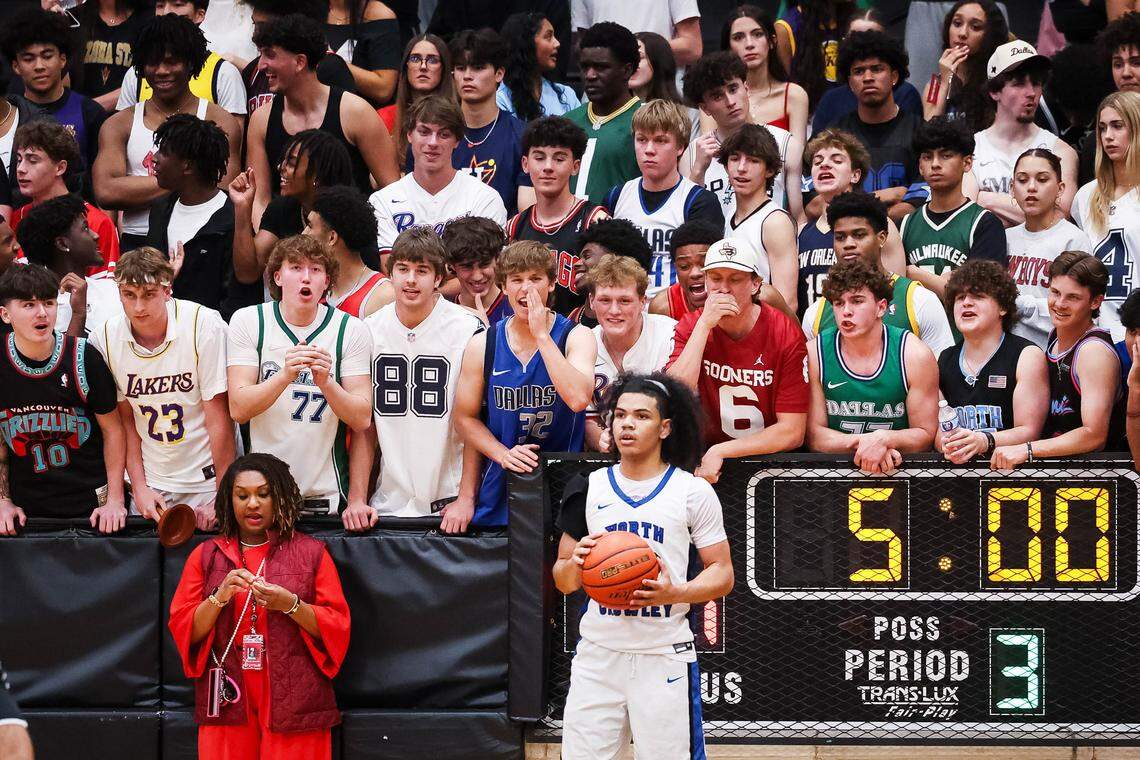 Coppell students scream and point toward North Crowley guard Isaak Hayes (22) as he inbounds the ball in a UIL 6A D1 regional semifinal at Timberview High School in Arlington, Texas, Tuesday, March 3, 2026.