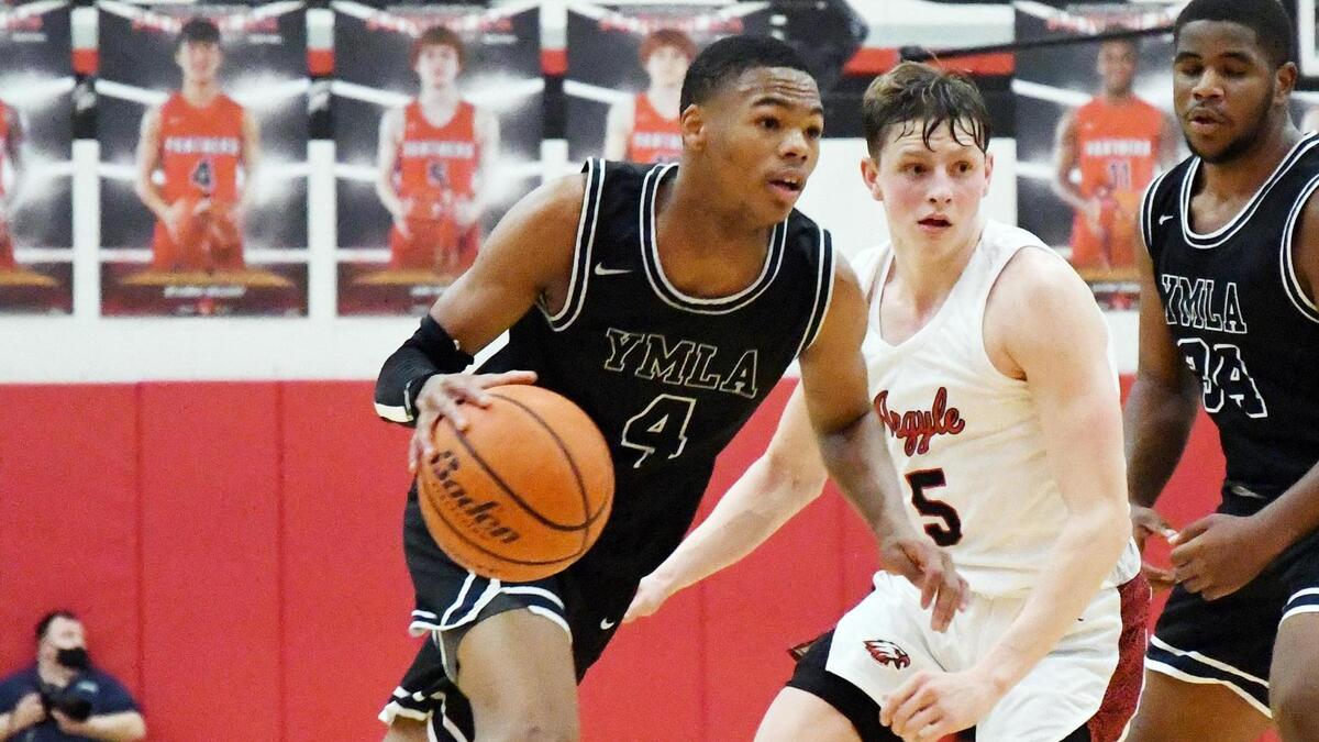 Young Men’s Learning Academy’s D’Monyae Davis, left takes the ball up the court past Argyle’s Slate McMellian during the fourth period of their 4A Region I Quarterfinal playoff game Saturday, February 27, 2021 at Colleyville Heritage High School in Colleyville, Texas. Argyle went on to win 49-40. Special/Bob Haynes