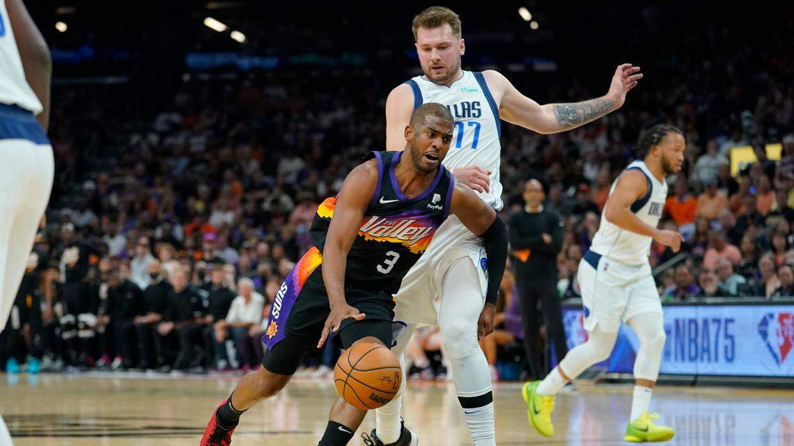 Phoenix Suns guard Chris Paul, left, drives past Dallas Mavericks guard Luka Doncic during Game 7 Sunday of a Western Conference playoff semifinal. Doncic finished with 35 points to lead the Mavs to a 123-90 win.