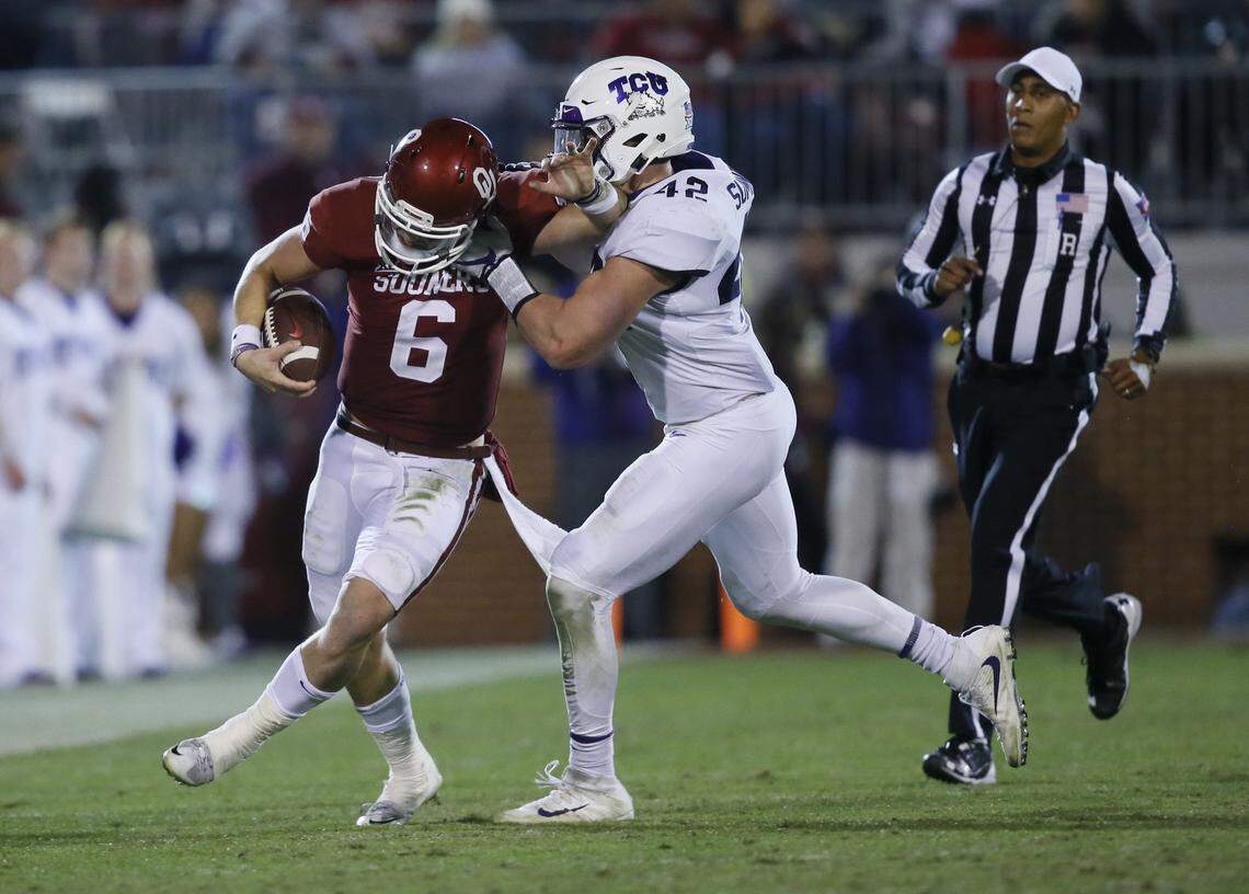 Oklahoma quarterback Baker Mayfield is pushed out of bounds by TCU linebacker Ty Summers during a game in November in Norman, Okla. Summers will take over Travin Howard's strong side linebacker position in 2018.