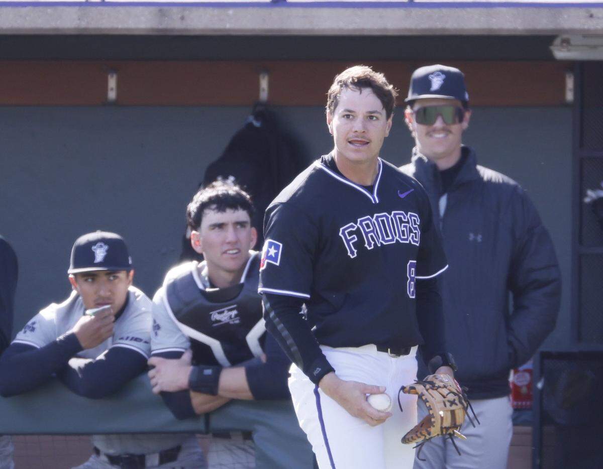 TCU first baseman Lane Hutchinson (8) comes up with the ball after colliding with pitcher Cade Nelson (34) in front of the New Mexico State dugout during an NCAA baseball game at Lupton Field at TCU in Fort Worth, Texas, Tuesday, March, 17, 2026.