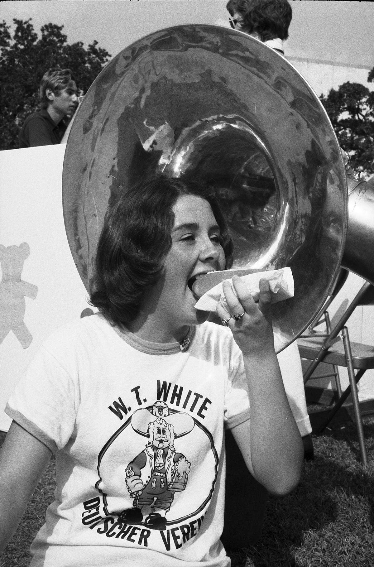 Oct. 27, 1974: Carol Johnson, 16, a junior at Dallas W.T. White High School, celebrated November Fest at the University of Texas at Arlington with a nibble of bratwurst to the rhythm of an oompah tuba.