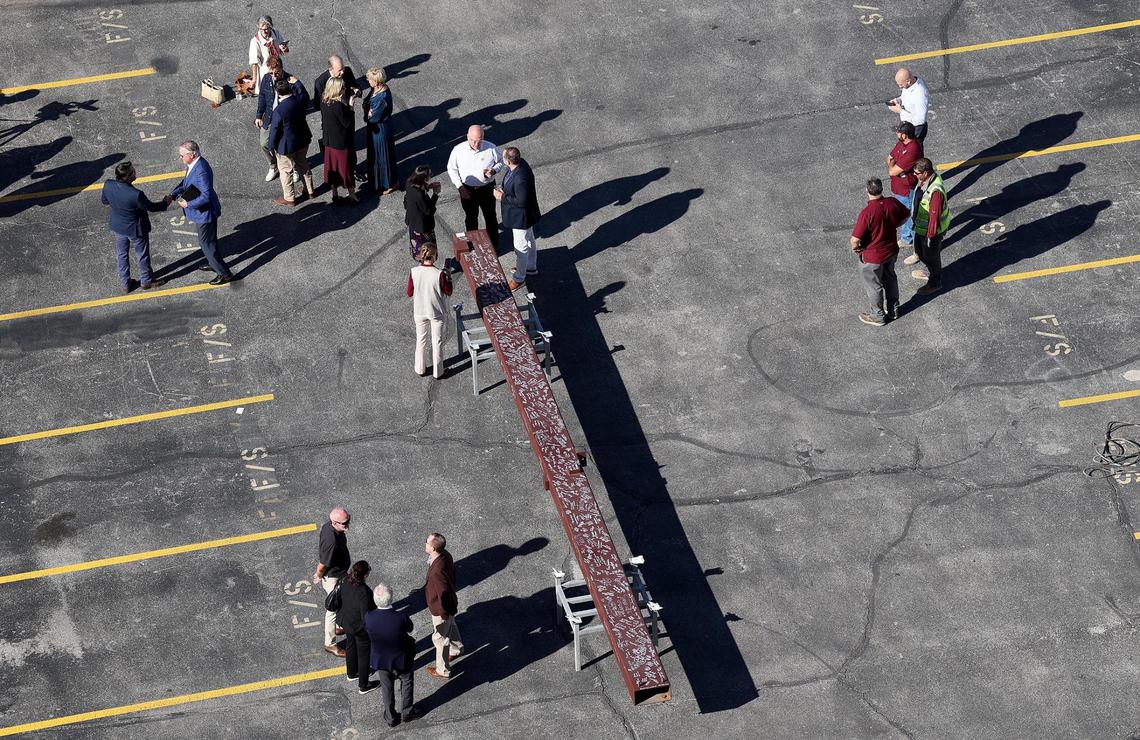 Guests sign their name to the final beam during topping out ceremony for the Texas A&M-Fort Worth Law and Education Building currently under construction on Monday, Nov. 11, 2024.