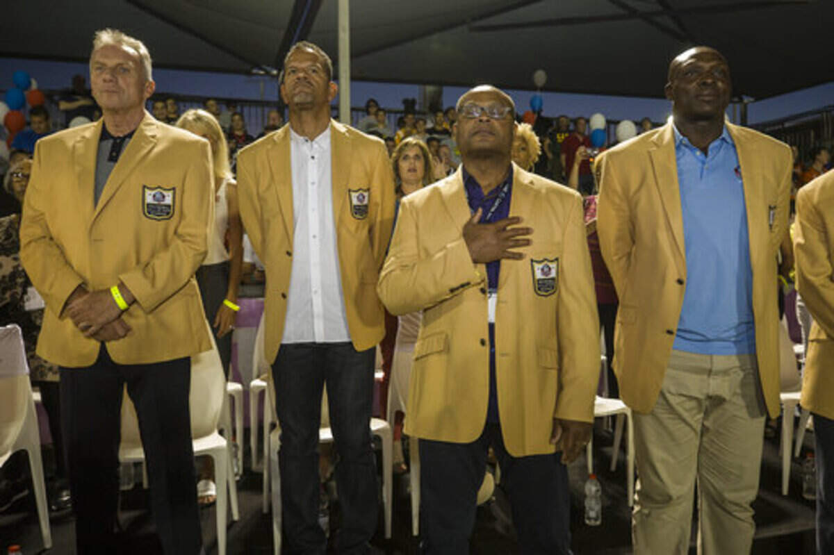 NFL Hall-of-Famer Mike Singletary (middle) has been named the new head football coach at Trinity Christian-Addison.