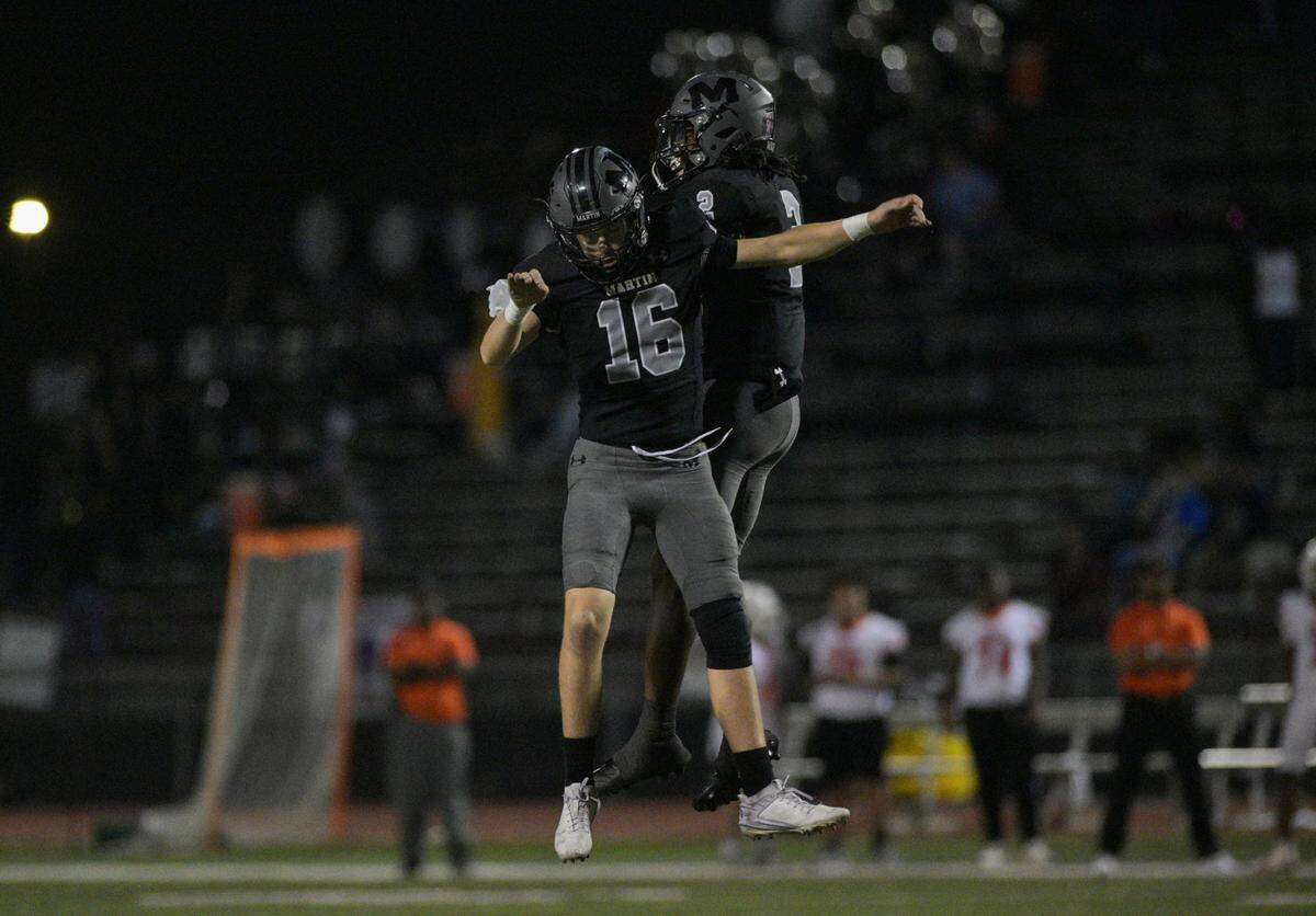 Martin Warrior wide receiver Trantan Miles (2) and quarterback Hunter Squires (16) celebrate during a UIL football game against Bowie High School at Cravens Field in Arlington, Texas on Friday, Oct. 11, 2024