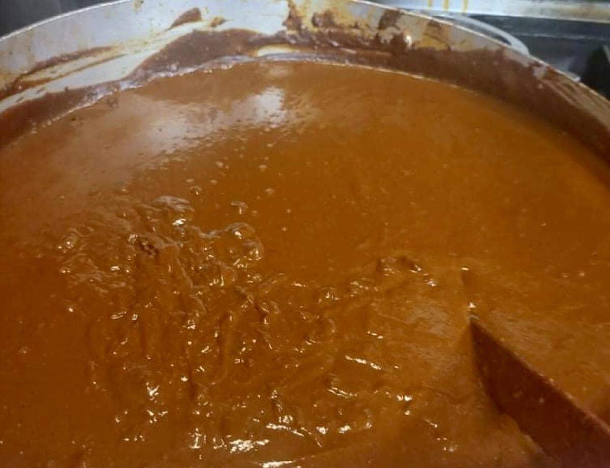 A pot of mole sauce stirring at Enchiladas Ole.