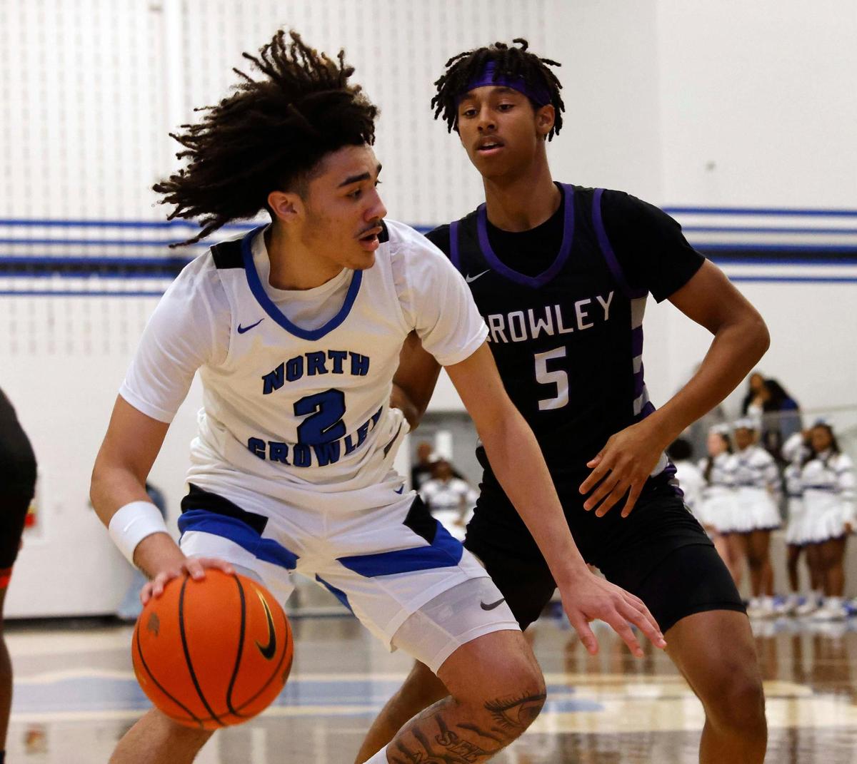 North Crowley guard Kamoni Sieber (2) drives the ball in front of Crowley guard Jonathan Fox (5) during the first period of a UIL basketball game at North Crowley High School in Fort Worth, Texas, Tuesday, Feb. 13, 2024.