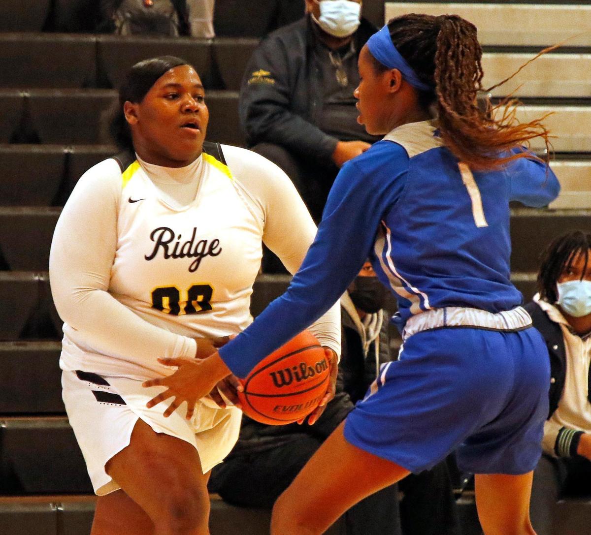 North Crowley guard Alaina Payne (1) boxes in Fossil Ridge’s LaKyla McSwain (00) in the corner during the first half of a 6A Region 1 Bi-district girls basketball game at Haltom High School in Haltom City, Texas, Friday, Feb. 12, 2021. Fossil Ridge led North Crowley 18-15 at the half. (Special to the Star-Telegram Bob Booth)