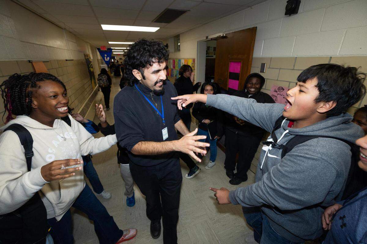 Omar Marquez, a restorative practices coach, is greeted by multiple students in the hallways during passing period at Applied Learning Academy in Fort Worth on Wednesday, Nov. 29, 2023.