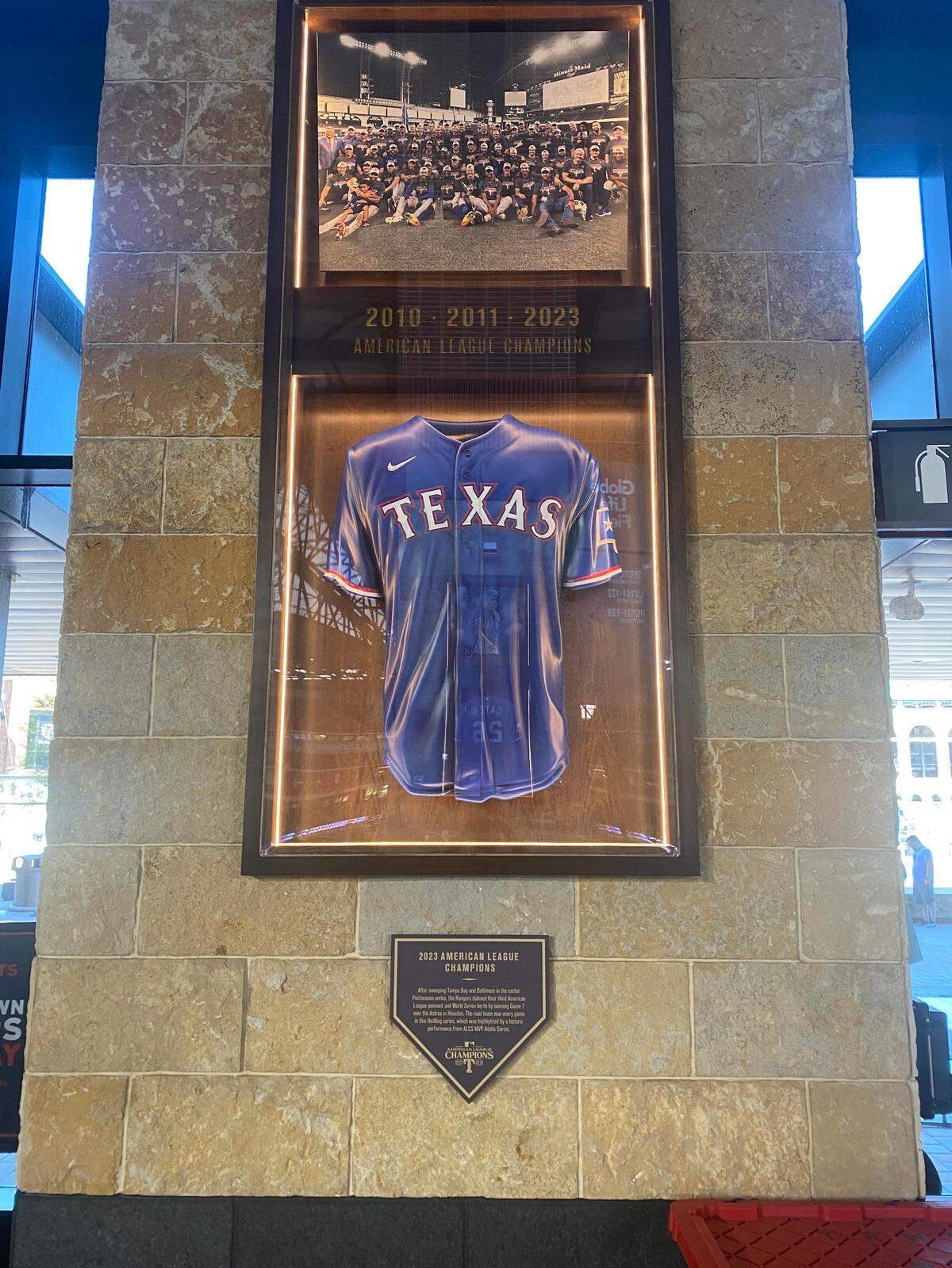 A framed Rangers jersey, photo and plaque located near section 140 at Globe Life Field.
