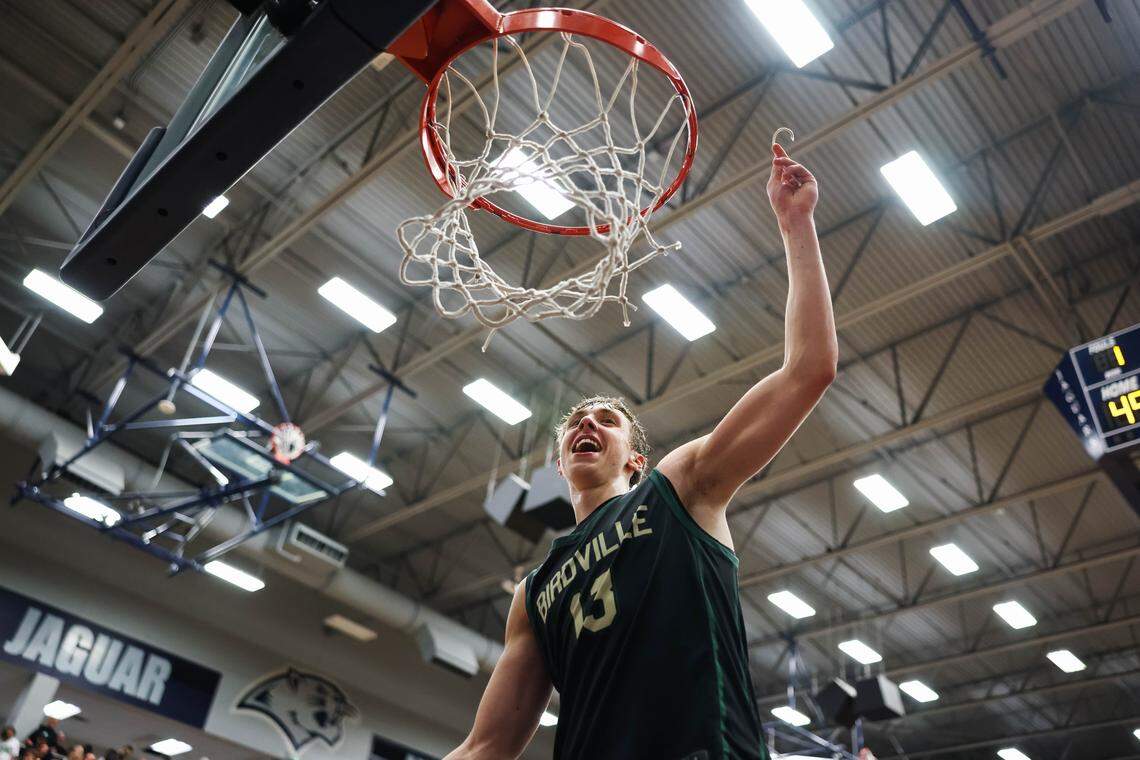 Birdville guard Avery Webb (13) holds a piece of the net in the air after clinching a spot in the state semifinals after a 50-49 UIL Class 5A Division I regional final win against Denton at Flower Mound High School in Flower Mound, Texas, Friday, March 6, 2026.