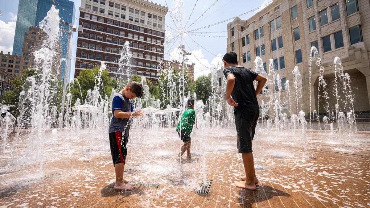Hans Jenseth, 7, left, and brothers Phoenix, 6, and Noah Earle, 12, play in the fountains at Sundance Square go off at Sundance Square Plaza in downtown Fort Worth on Wednesday, July 24, 2024.