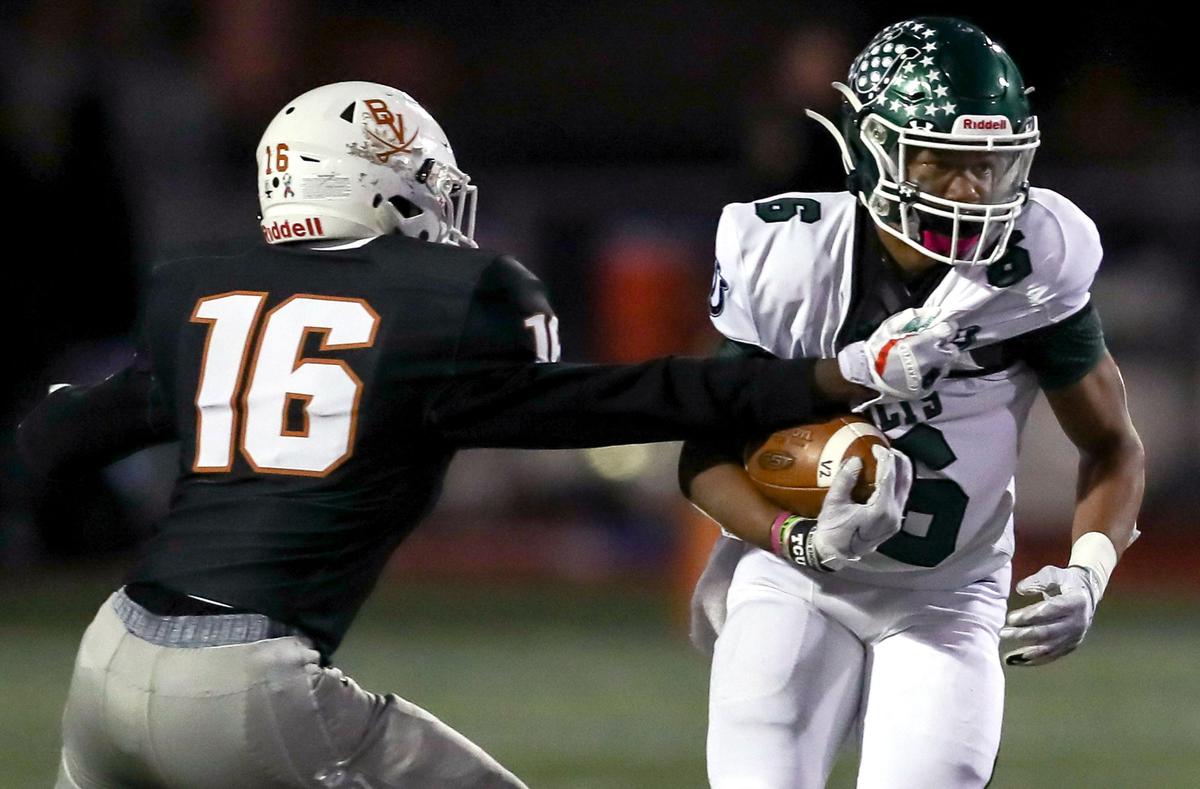 Arlington running back BJ Rogers (6) tries to break free of Arlington Bowie defensive back Chris Roshell (16) during the first half, Friday night, October 11, 2019 played at Wilemon Field in Arlington, TX.