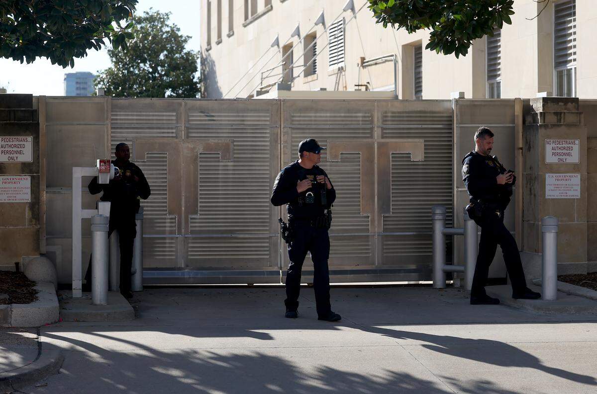 Homeland Security officers stand guard outside the federal courthouse in downtown Fort Worth on Thursday, March 12, as the jury deliberated in the trial against nine defendants indicted in connection to the nonfatal shooting of a police officer outside a North Texas ICE detention center last year.