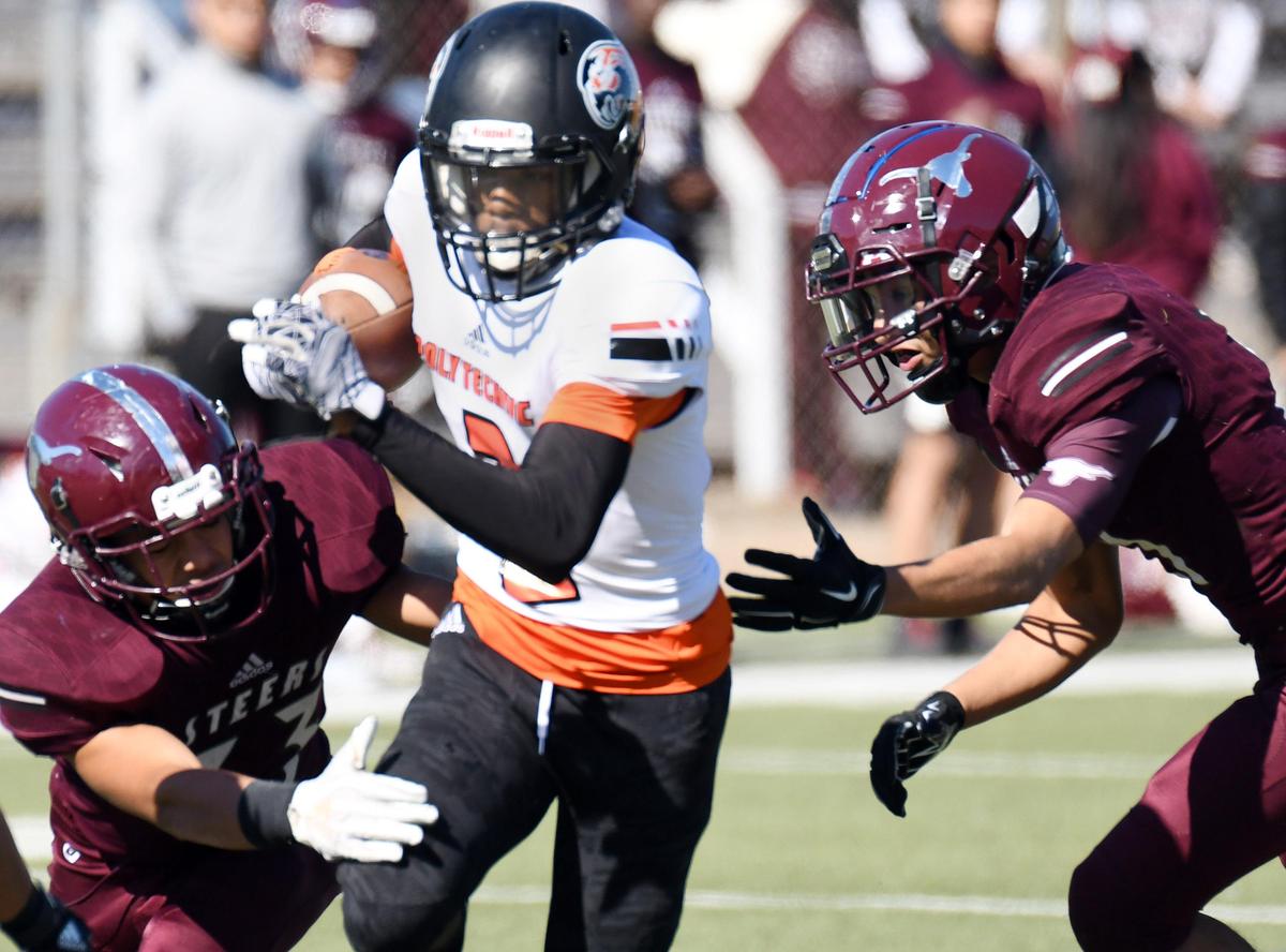 Polytechnic’s Anthony Phenix,center races through North Side’s Adrian Martinez and Isaiah Torrez for a first down in the second quarter during Saturday’s November 2, 2019 football game at Scarborough-Handley Field in Fort Worth, Texas. Special/Bob Haynes