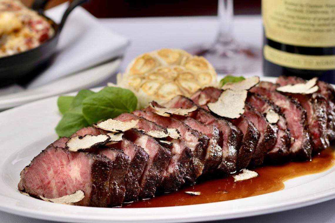 A 30-day dry-aged sliced New York strip steak with sliced black summer truffles, as seen April 21, 2023, at an unindentified location of The Capital Grille.
